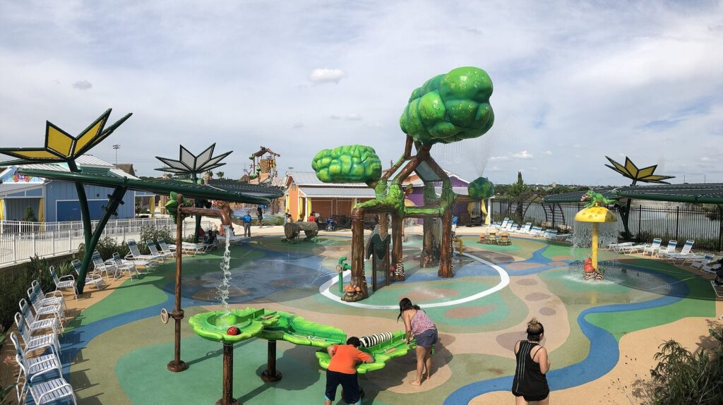 The colorful splash pad at Morgan's Inspiration Island with water features, play structures and lounge chairs, one of the most wheelchair accessible San Antonio attractions