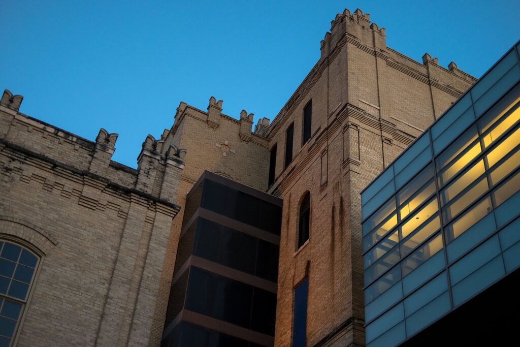 Crenellated brick towers of the former Lone Star Brewery joined by a glass walkway, home of one of the best museums in San Antonio