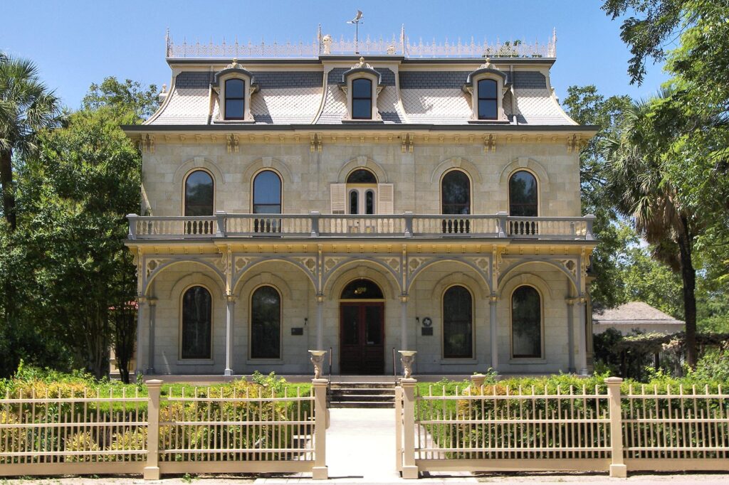 The ornate limestone Steves Homestead with its mansard roof and arched porches in the King William district, one of the San Antonio cultural districts