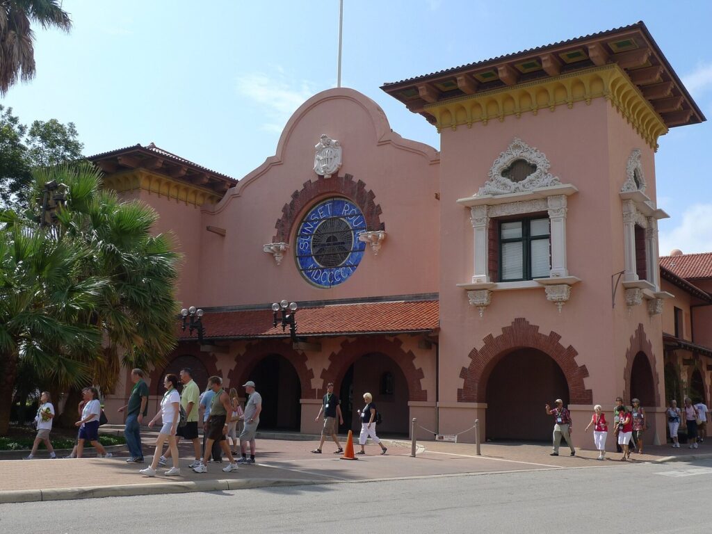 The ornate pink Spanish Mission-style Sunset Station depot with arched windows and a round medallion