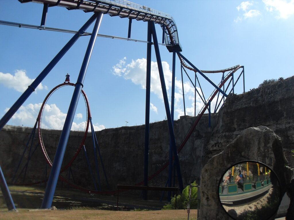 The blue track and red loop of the Superman Krypton Coaster against the limestone quarry walls at Six Flags Fiesta Texas
