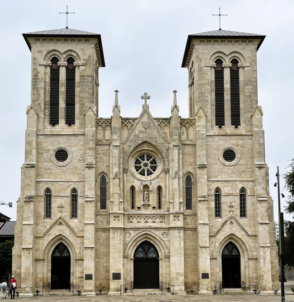 The twin Gothic Revival towers and rose window of San Fernando Cathedral facing Main Plaza in San Antonio